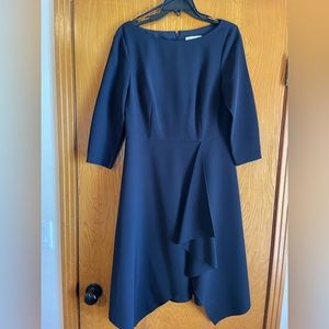 Navy 3/4 sleeve knit dress with asymmetrical hem.